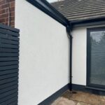 Rendering insulation costs process applied to house wall