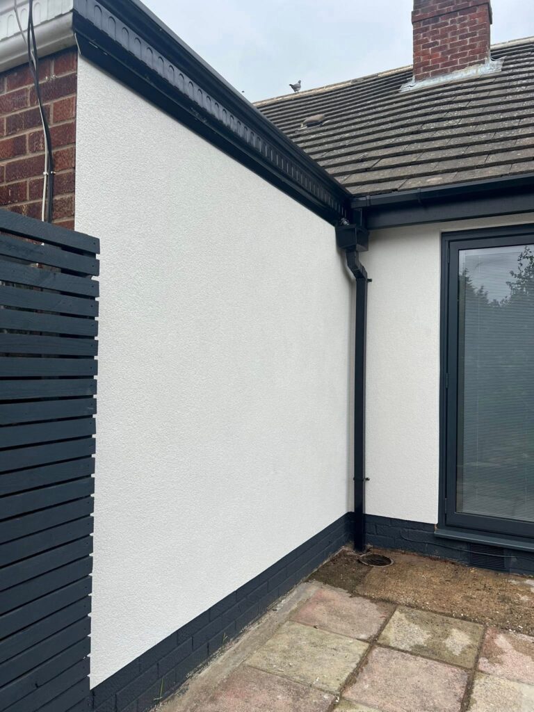 Rendering insulation costs process applied to house wall